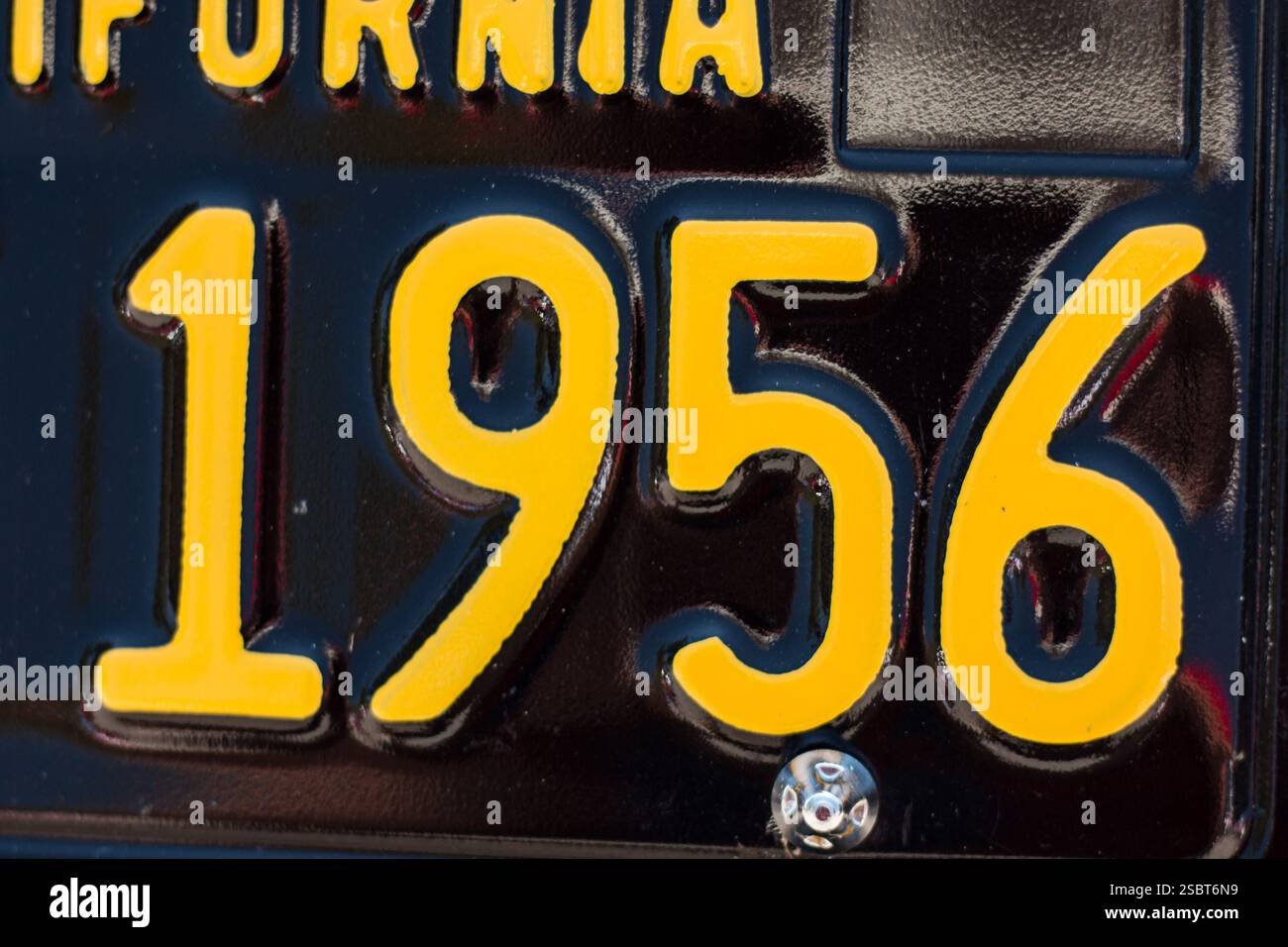 Una targa californiana nera e gialla di vecchio stile con i numeri 1956. Foto Stock
