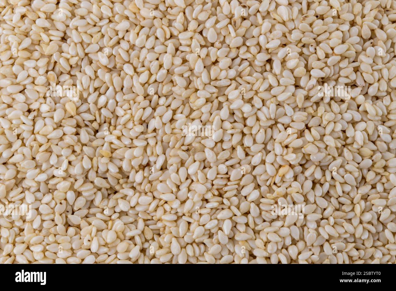 Semi di sesamo. Background alimentare. Fonte vegetale di calcio. Una corretta alimentazione. Foto Stock