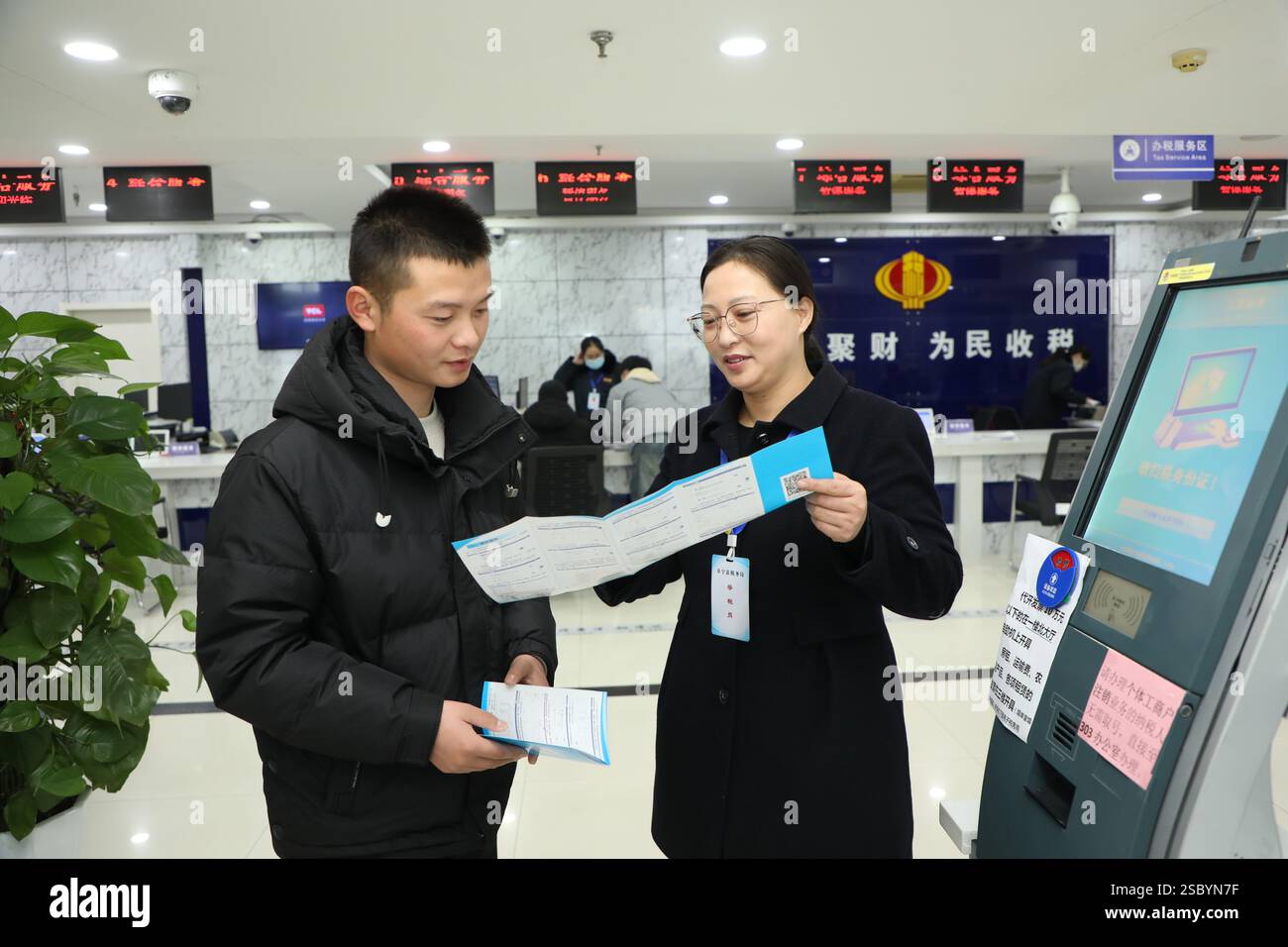 YANCHENG, CINA - 5 FEBBRAIO 2025 - Un membro del personale del centro di servizio per gli affari governativi gestisce le attività connesse per le masse nella contea di Funing, Foto Stock