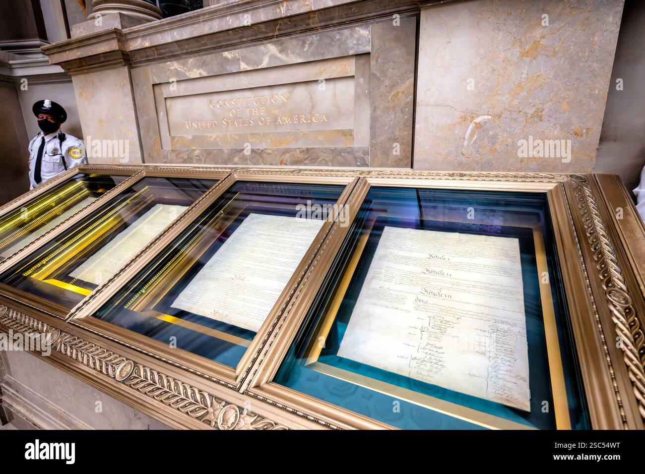 WASHINGTON DC - la Costituzione originale degli Stati Uniti, ospitata in un caso di conservazione specializzato, è esposta nel National Archives Rotunda. Questo storico documento pergamena di quattro pagine del 1787 si trova in un involucro protettivo in titanio e alluminio riempito con gas argon inerte, consentendo ai visitatori di visualizzare il documento legale di base americano, garantendo al contempo la sua conservazione a lungo termine. Foto Stock