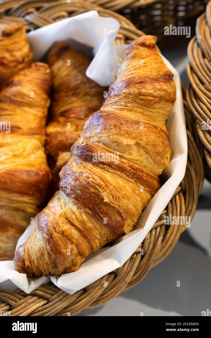 Pane e dolci, cestino con croissant francesi in mostra sul tavolo colazione continentale Foto Stock