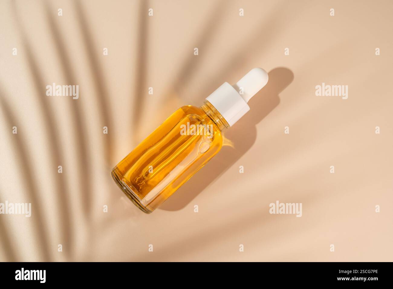 Flacone contagocce arancione con siero o olio di vitamina C. Prodotto per la cura del viso e dei capelli di bellezza. Marketing linea di produzione Foto Stock