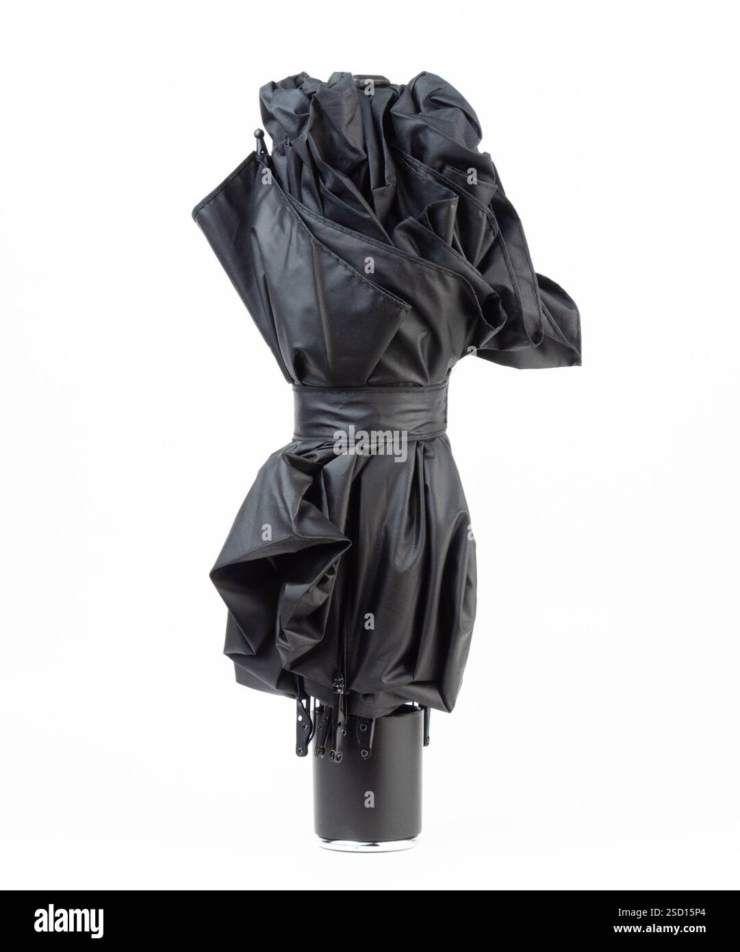 Un elegante ombrello nero è in piedi con un design elegante su uno sfondo semplice Foto Stock