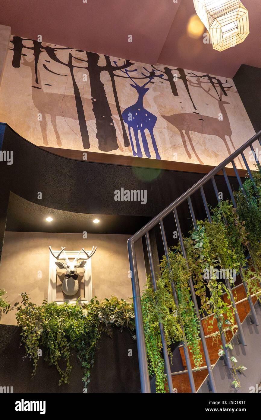 Esplorando un interno moderno adornato con arte ispirata alla natura e verde tranquillo in Giappone Foto Stock