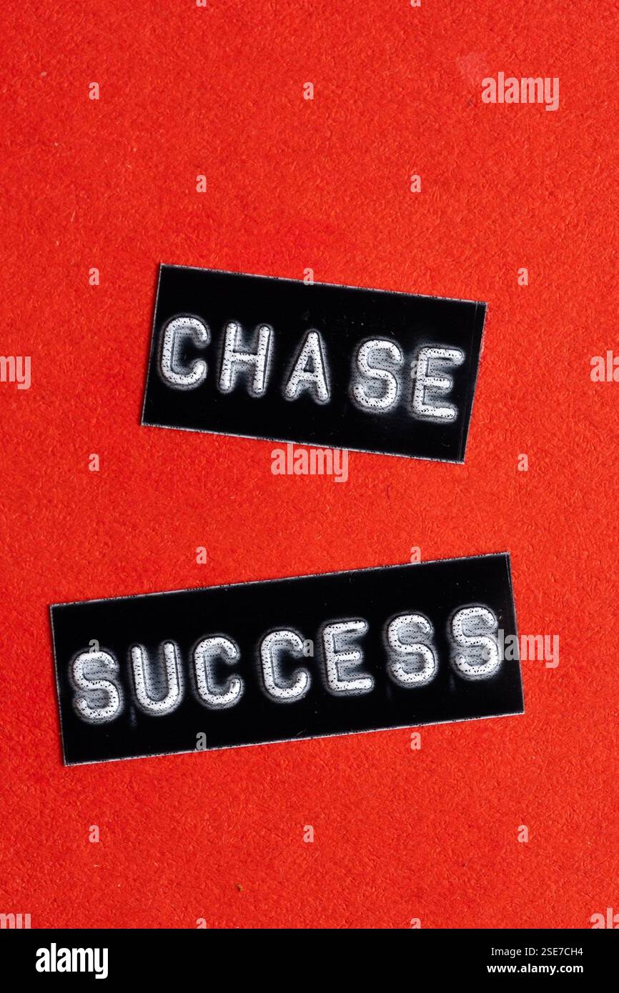 Primo piano due tag neri con parole Chase Success su sfondo rosso Foto Stock