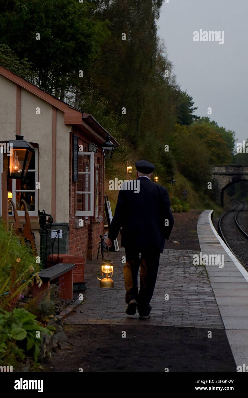Il personale volontario della stazione accende lampade a olio d'epoca presso la stazione di Eardington, la Severn Valley Heritage Railway, lo Shropshire, l'unica stazione del Regno Unito illuminata da lampade a olio Foto Stock