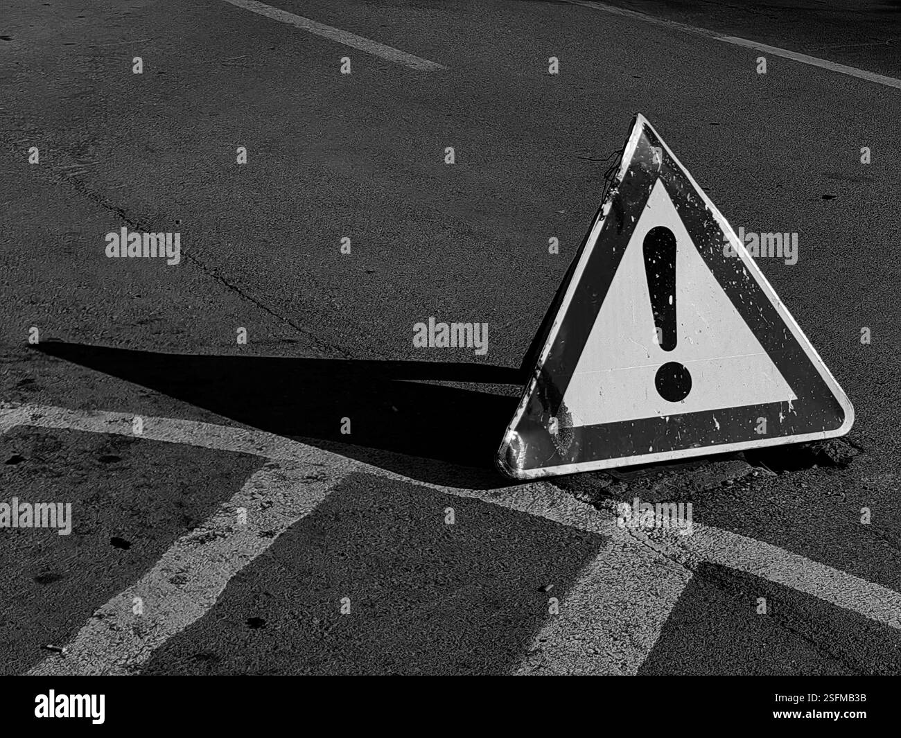 Attenzione davanti a te - segnale stradale triangolare su asfalto Foto Stock