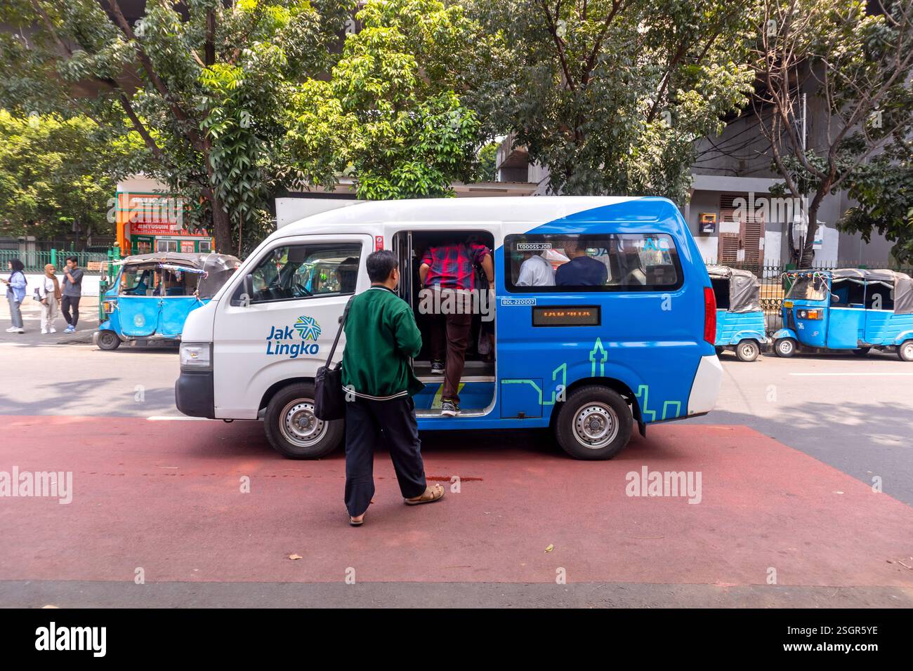 Giacarta, Indonesia - 10 agosto 2024: Un minibus pubblico o un'auto di trasporto pubblico ferma per prelevare i passeggeri sulla strada di Giacarta Foto Stock