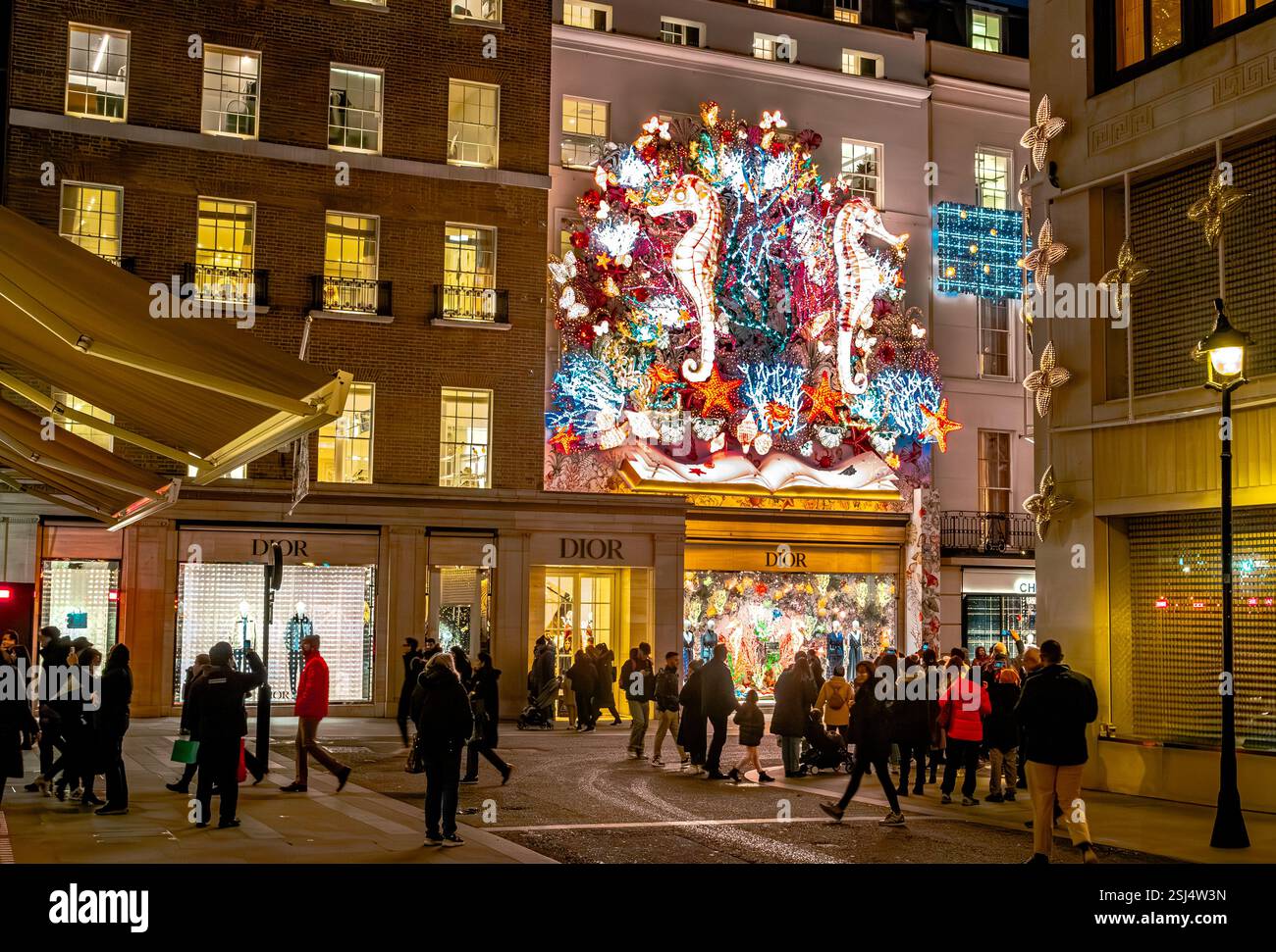 Una grande decorazione natalizia mostra sopra il negozio Dior in Old Bond Street, Mayfair, London W1 Foto Stock