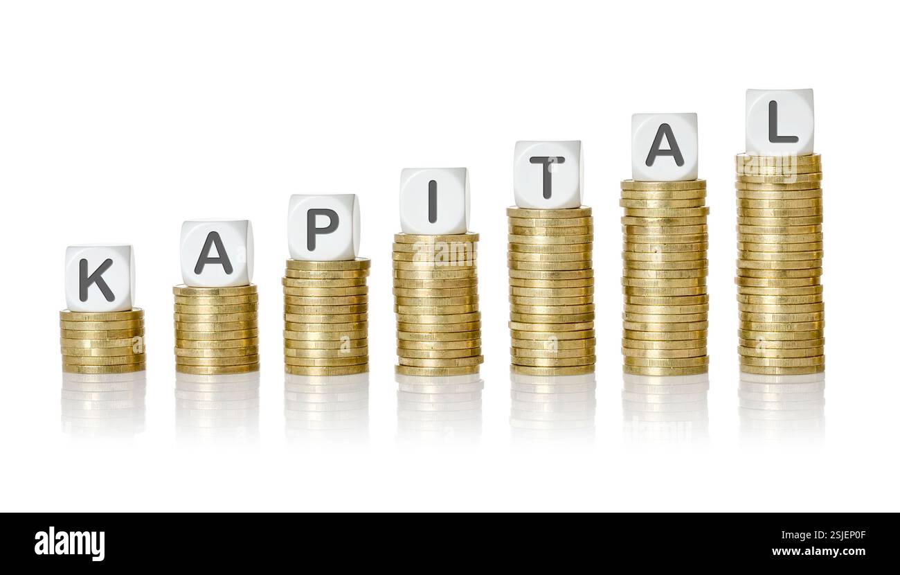 Pila di monete con cubi di lettere - capitale Foto Stock