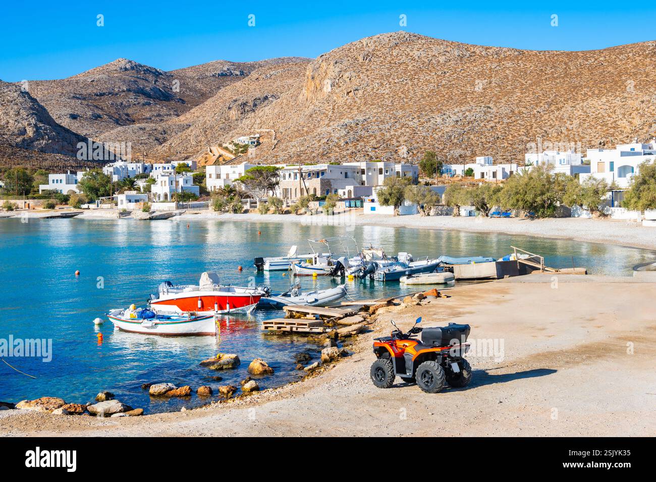 Vista della spiaggia nel porto di Karavostasis con montagne sullo sfondo, isola di Folegandros, Cicladi, Grecia Foto Stock