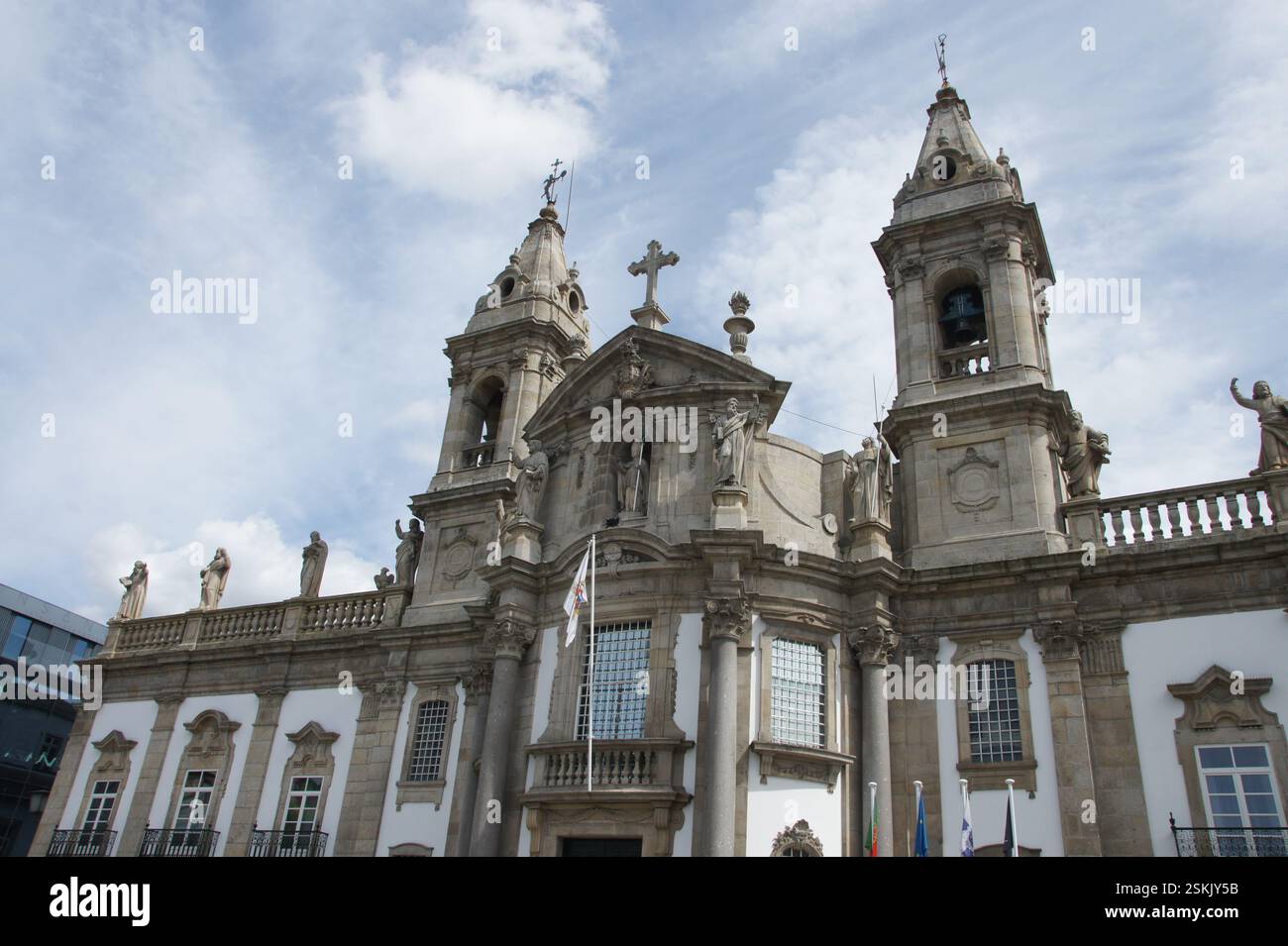Impressionante facciata barocca della chiesa. L'edificio è impreziosito da intricati lavori in pietra. I due campanili si innalzano sopra la città. Un potente simbolo di fede e di istoria Foto Stock