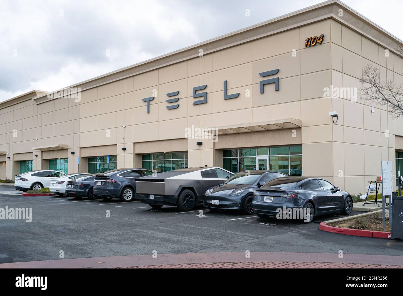 Ingresso esterno di un centro di assistenza e riparazione Tesla con cybertruck. Foto Stock