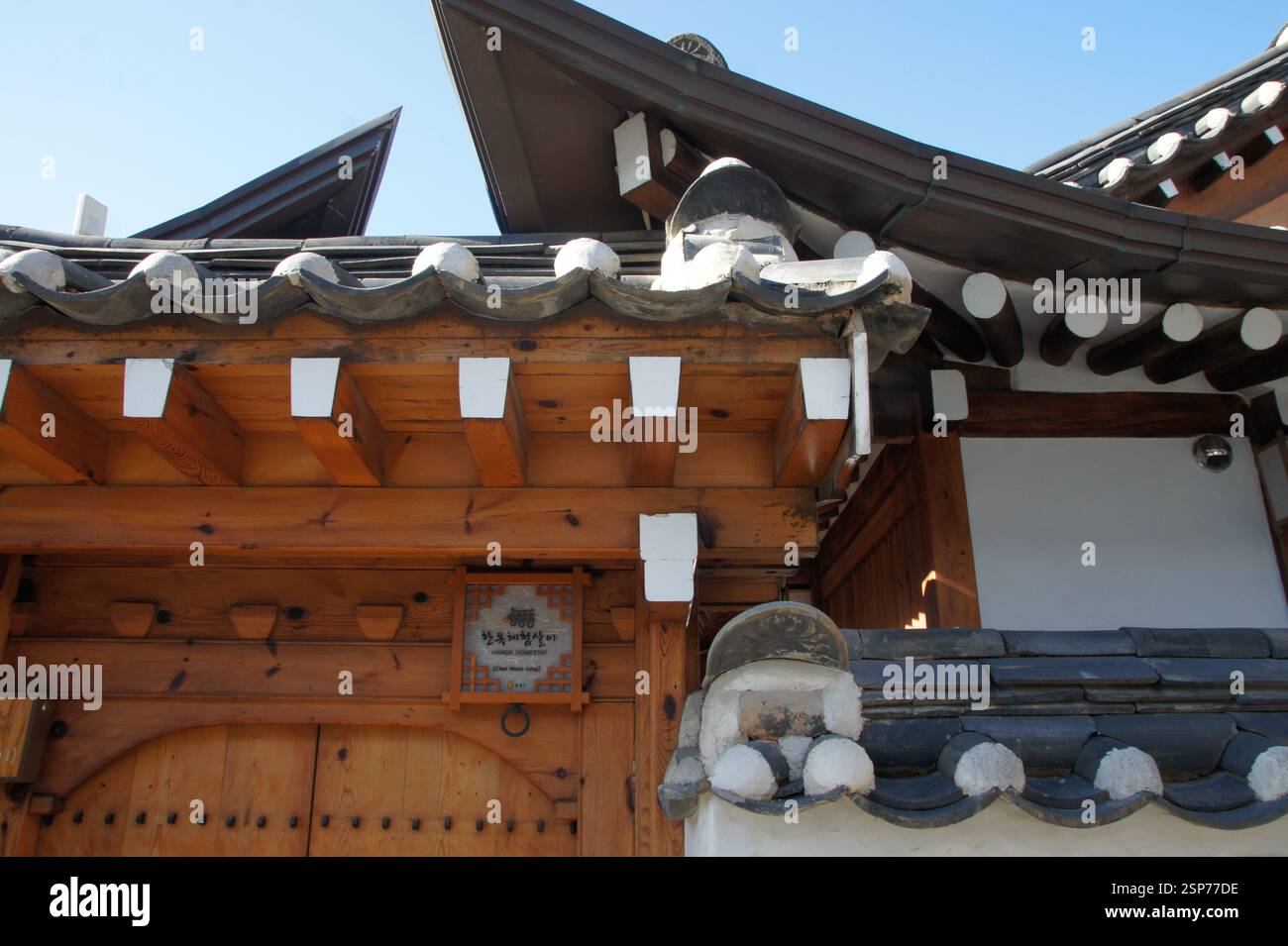 Hanok coreano. Tetto piastrellato, travi in legno, pareti bianche. Casa coreana tradizionale con caratteristiche architettoniche uniche. Simbolo della storia e della cultura coreana Foto Stock