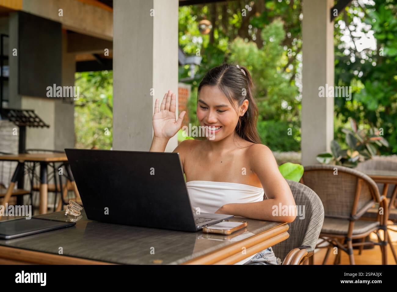 Giovane donna che lavora su un notebook nel concetto di ristorante Foto Stock