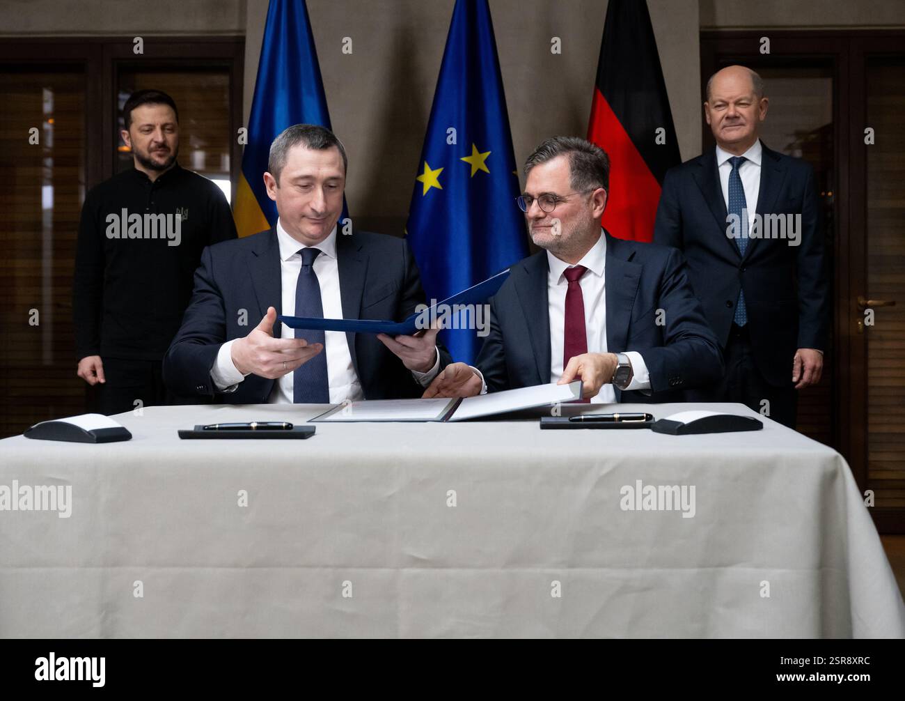 Monaco, Germania. 15 febbraio 2025. Volodymyr Selenskyj (l-r), Presidente dell'Ucraina, Oleksiy Chernyshov, Vice primo Ministro dell'Ucraina, capo della Cancelleria Wolfgang Schmidt (SPD) e Cancelliere federale Olaf Scholz (SPD) firmano una dichiarazione d'intenti sui "centri di unità" ucraini alla Conferenza sulla sicurezza di Monaco. La 61a Conferenza sulla sicurezza di Monaco (MSC) si terrà dal 14 al 16 febbraio 2025 presso l'Hotel Bayerischer Hof di Monaco. Credito: Sven Hoppe/dpa Pool/dpa/Alamy Live News Foto Stock