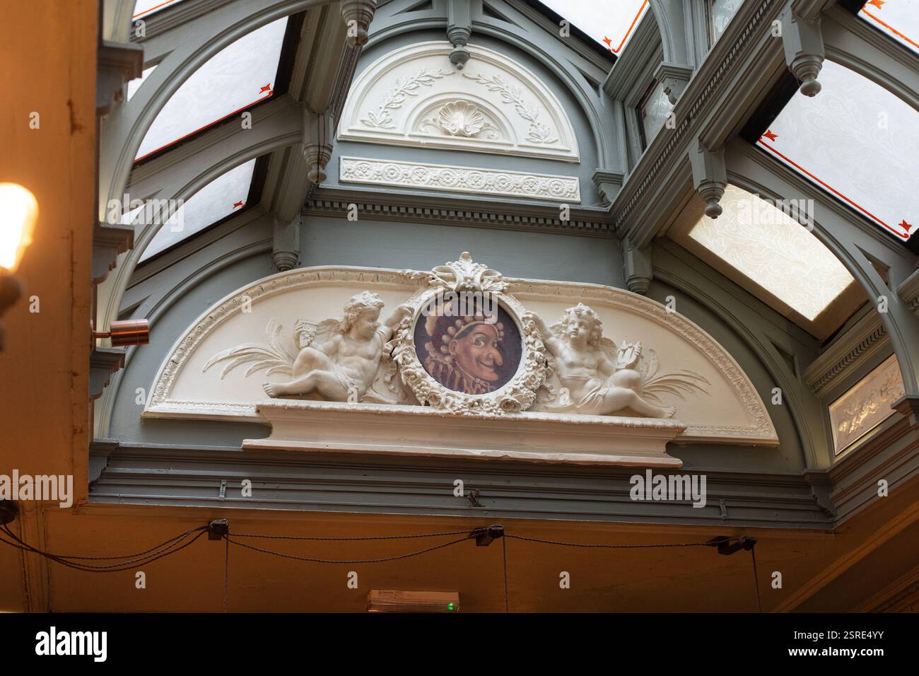Dettagli architettonici decorati, i cherubini fiancheggiano un giullare dipinto. Soffitto decorativo. La punch Tavern è una casa pubblica classificata di grado II al 98–100 Fleet Stree Foto Stock