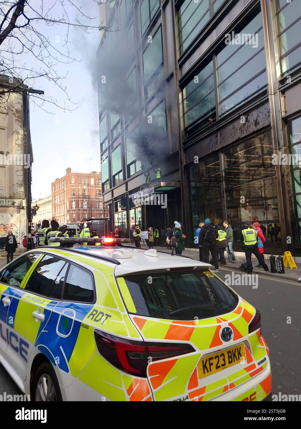 Londra, Regno Unito. 17 febbraio 2025. I manifestanti che indossano il marchio Extinction Rebellion si rivolgono agli uffici della McKinsey & Company di Holborn, spruzzando vernice nera che ricopre il vetro frontale e un aspetto performativo. I manifestanti si sono arrampicati sulla cima della tettoia di vetro sopra l'ingresso. © Amstel Adams/ Alamy Live News Foto Stock