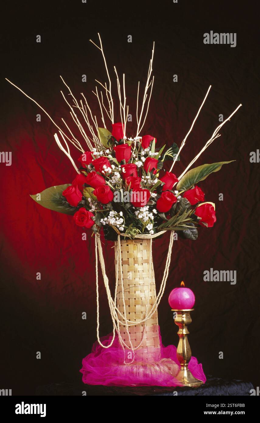 Bouquet, fiori di rose rosse con candela Foto Stock