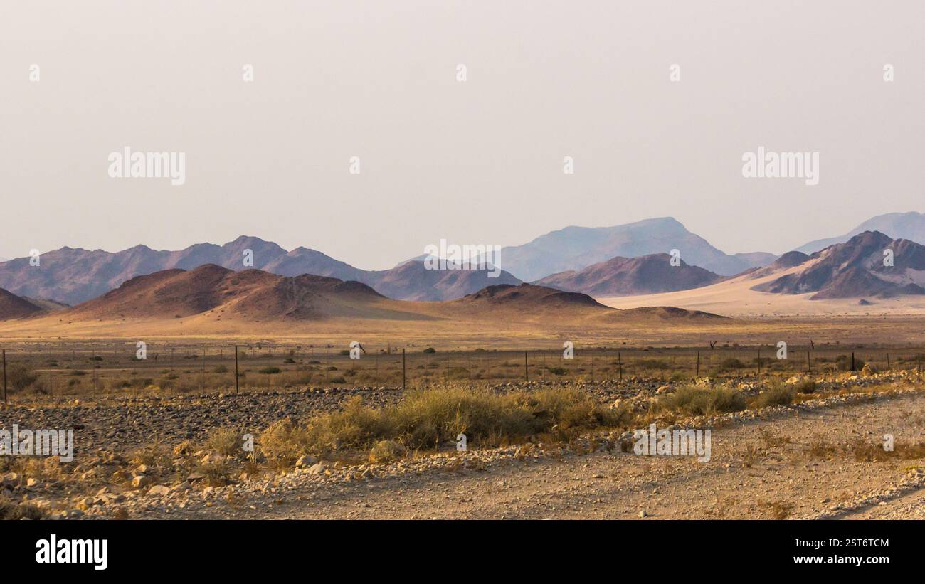Le vaste pianure battute dal vento sul bordo del deserto del Namib, con le colline ai piedi dei monti Naukluft all'orizzonte, Foto Stock