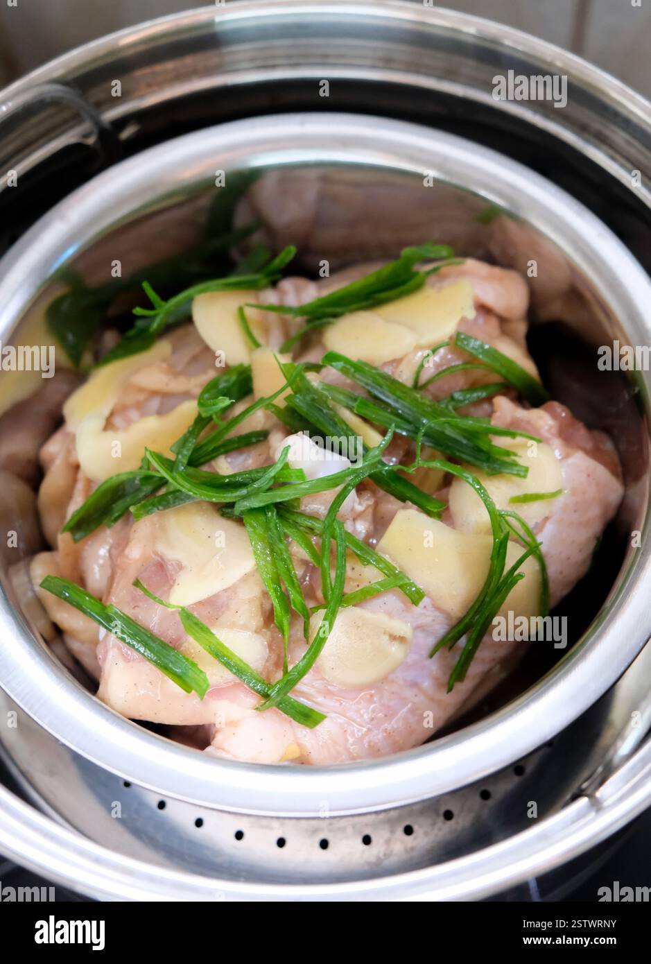 Cottura del pollo al vapore allo zenzero con olio di cipolla primaverile. Foto Stock
