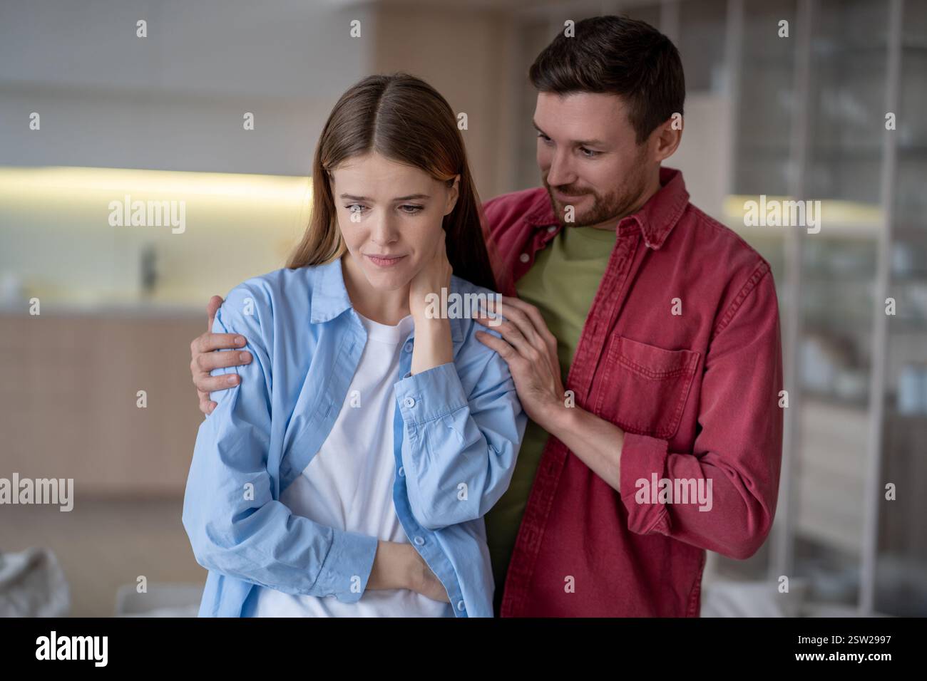 L'uomo calmo che tira su una donna preoccupata, abbracciando le spalle, fornisce supporto morale alla moglie sconvolta. Foto Stock