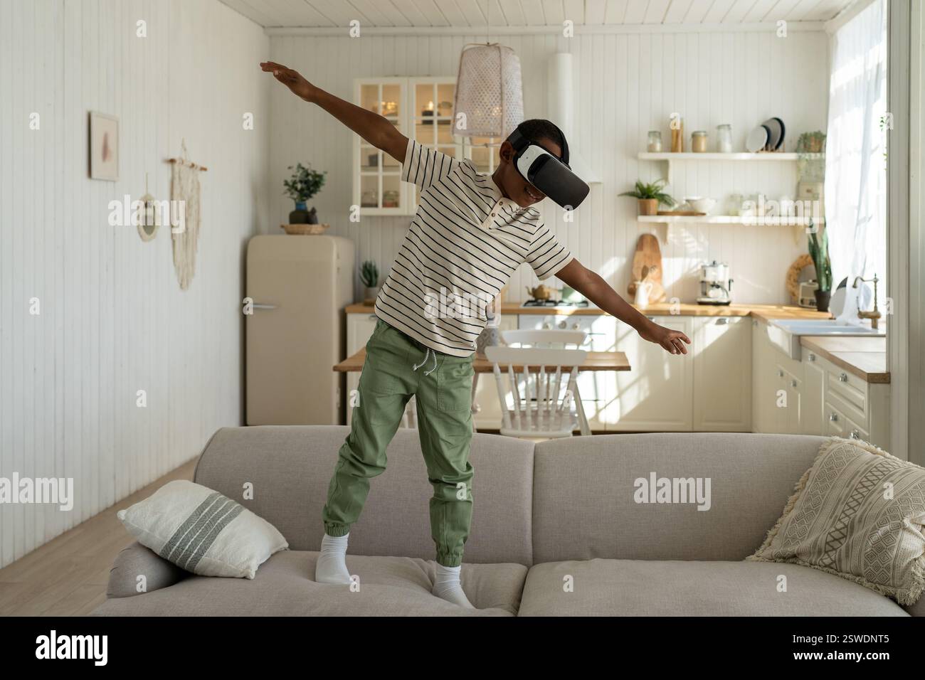 African american ragazzo in 3D occhiali di realtà virtuale gioca gioco e volare. Scolaro è piani di studio Foto Stock