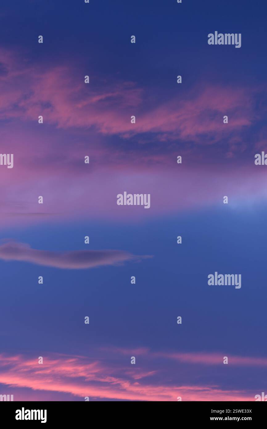 Le tonalità rosa e viola dipingono il cielo crepuscolo con uno spettacolo mozzafiato al tramonto Foto Stock