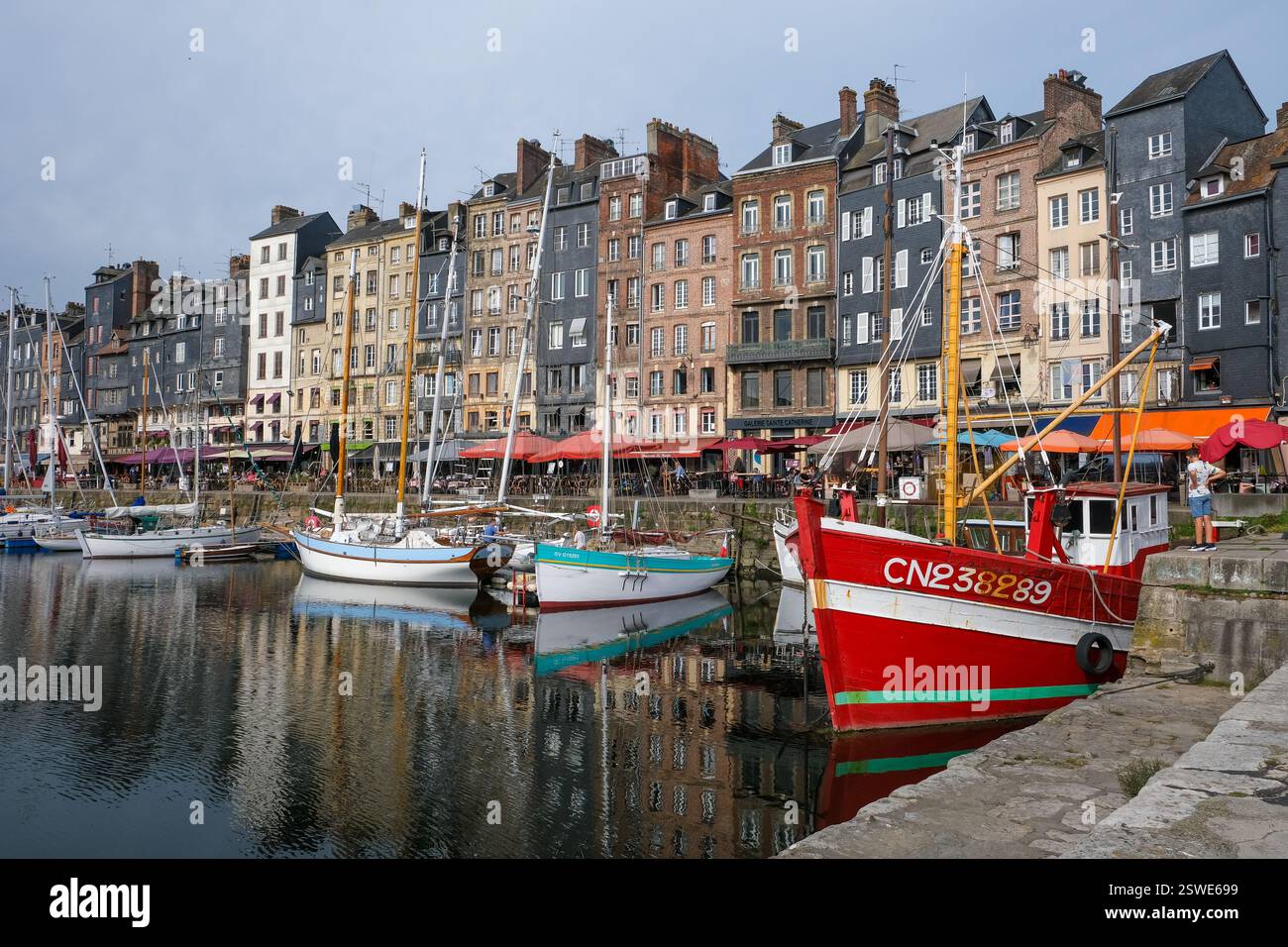 30.08.2024, Francia, Normandia, Honfleur - barche al Quai Sainte-Catherine nel vecchio porto, Vieux Bassin, nella pittoresca cittadina portuale di Honfleu Foto Stock