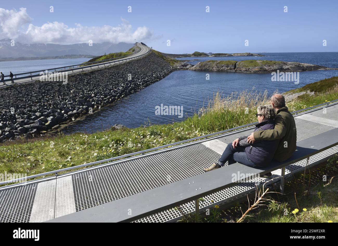 Coppia seduta su una panchina sulla Atlantic Road in Norvegia Foto Stock