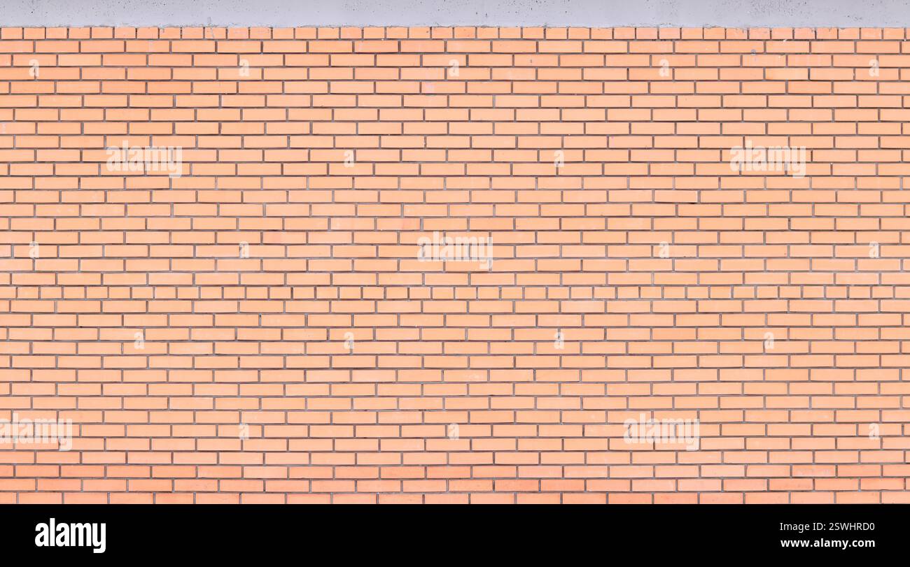 Struttura muraria, sfondo. Sfondo in mattoni arancioni per il design esterno. Concetto di costruzione, edifici all'aperto, garage o casa. Muro con Foto Stock