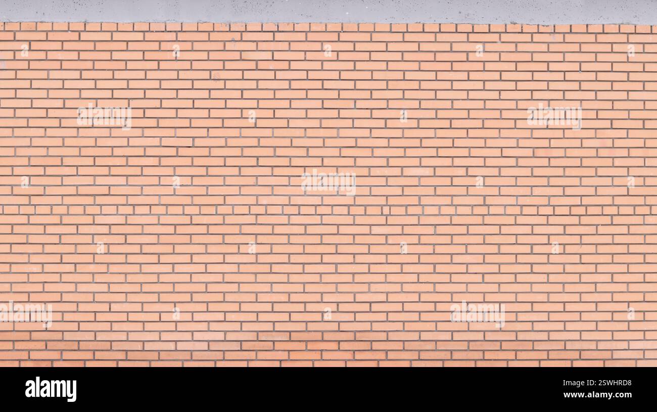 Struttura muraria, sfondo. Sfondo in mattoni arancioni per il design esterno. Concetto di costruzione, edifici all'aperto, garage o casa. Muro con Foto Stock