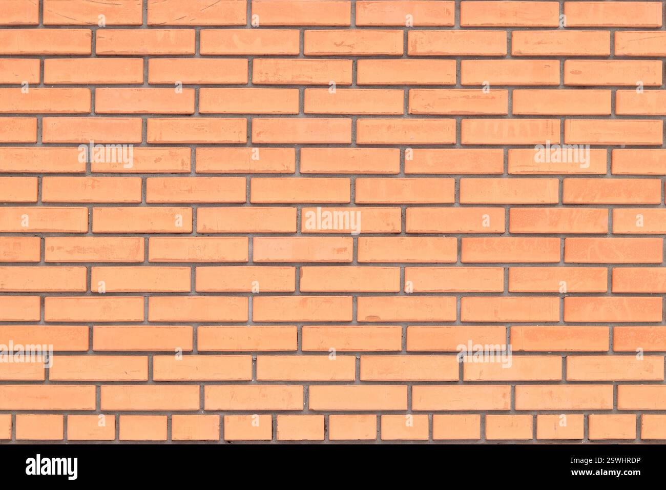 Struttura muraria, sfondo. Sfondo in mattoni arancioni per il design esterno. Concetto di costruzione, edifici all'aperto, garage o casa. Muro con Foto Stock