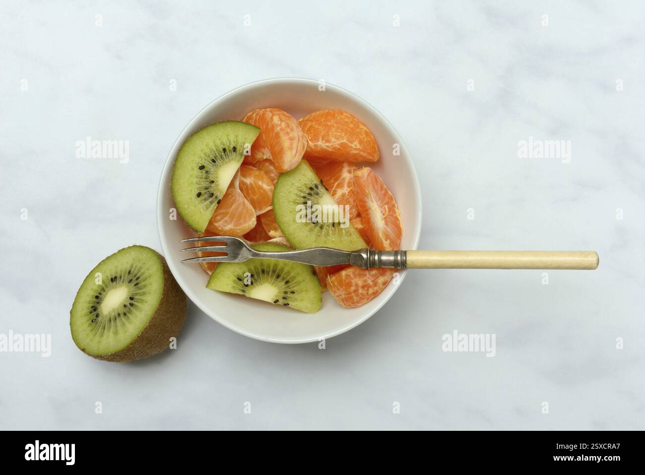 Pezzetti di Clementine e fette di kiwi in buccia Foto Stock