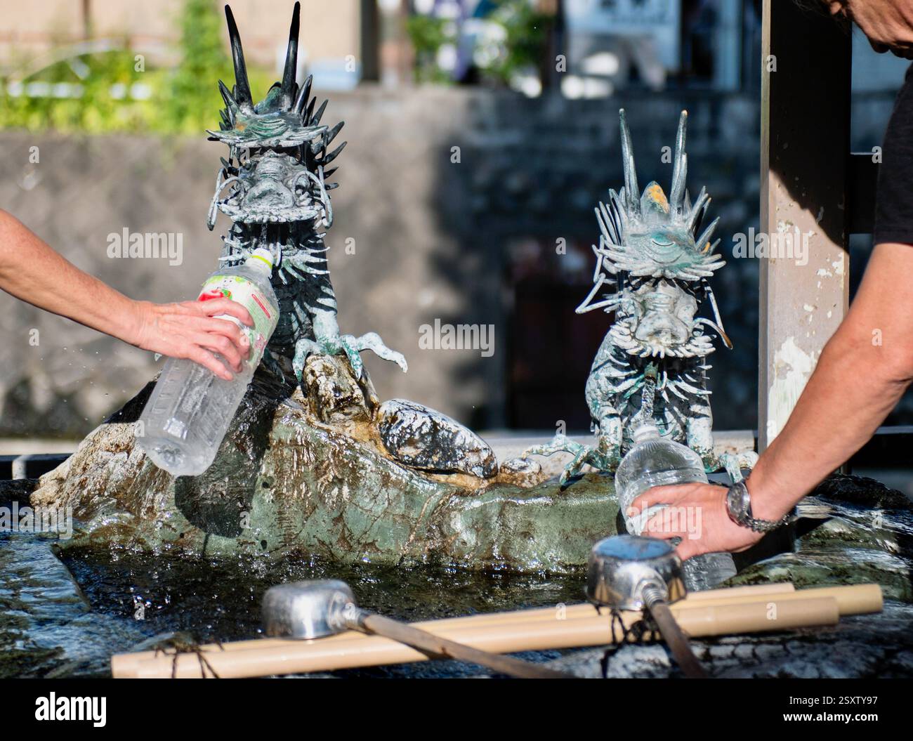 I residenti raccolgono l'acqua sorgiva in una delle sorgenti lungo il fiume Itachi a Toyoma City, Giappone, il 13 settembre 2017. ROBERT GILHOOLY Foto Stock