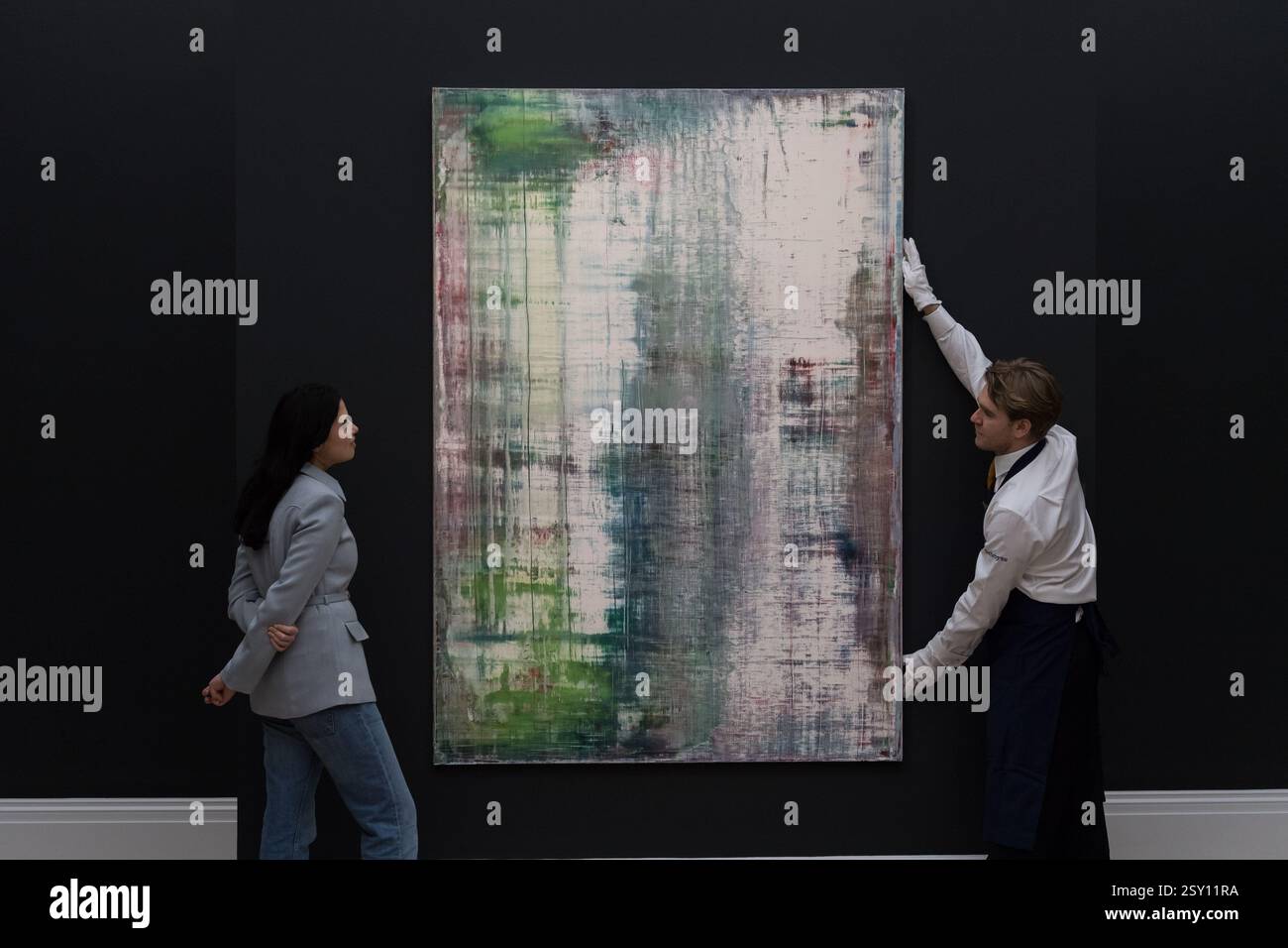 Londra, Regno Unito. 26 febbraio 2025. LONDRA, REGNO UNITO - 26 FEBBRAIO 2025: I membri dello staff posano con un dipinto di Gerhard Richter "Heu", stima: £ 5.000.000 - 7.000.000 durante una fotochiamata alla casa d'aste di Sotheby che mostra i punti salienti di Modern & Contemporary Art Sales a Londra, Regno Unito, il 26 febbraio 2025. (Foto di Wiktor Szymanowicz/NurPhoto) credito: NurPhoto SRL/Alamy Live News Foto Stock