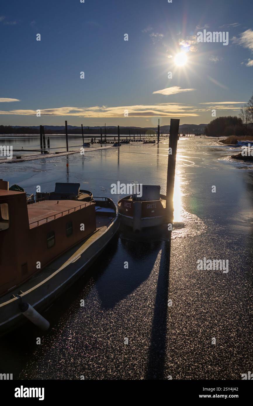 Congelate nel tempo: Le barche di metallo riposano racchiuse nel ghiaccio, una volta lavoravano nelle acque di Fetsund Lenser, riflettendo ora la luce invernale Foto Stock