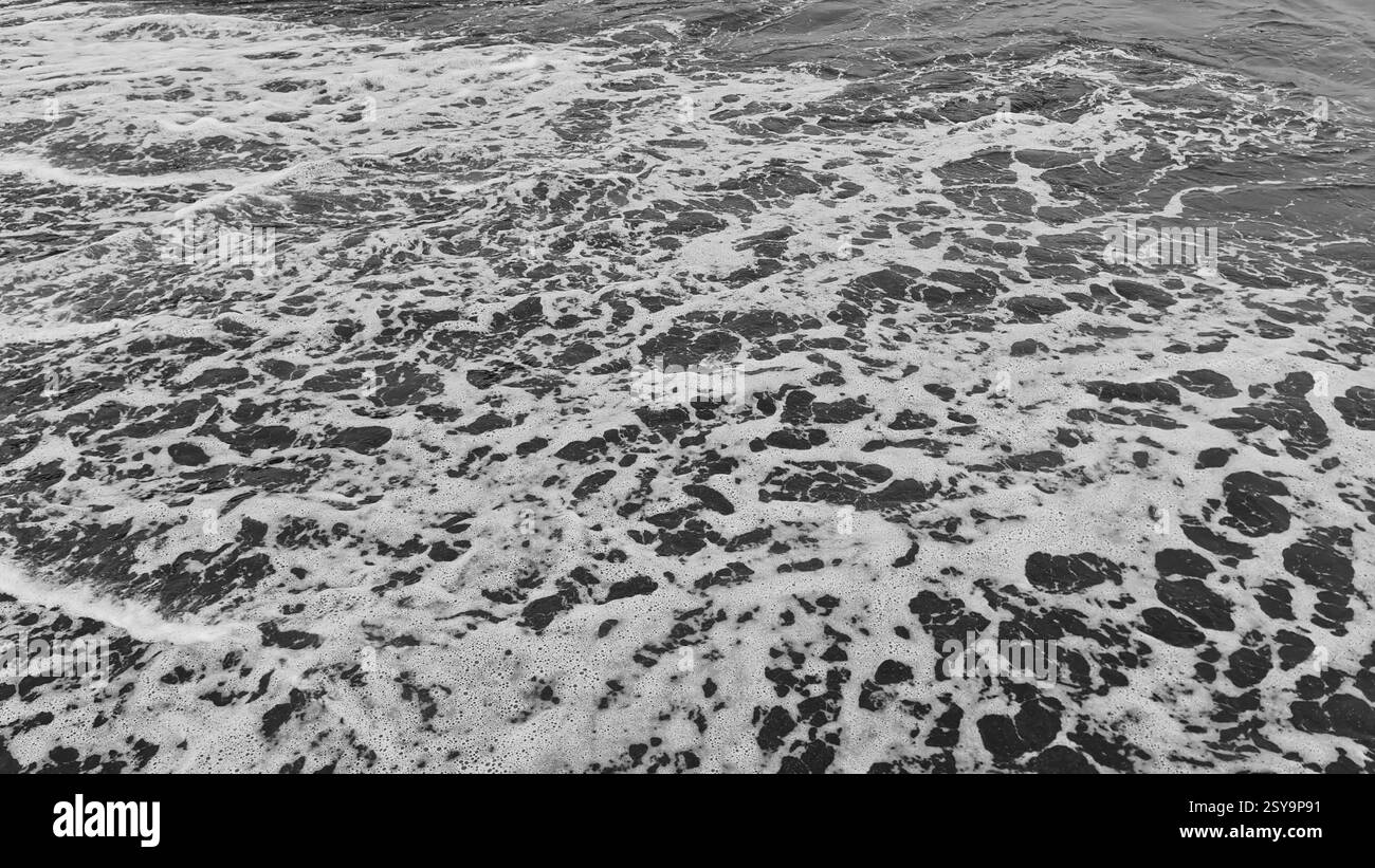 Vista sul mare dalla spiaggia con sabbia nera Foto Stock