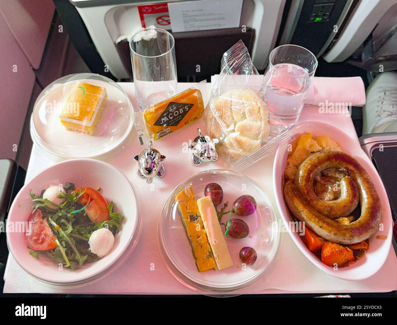 In rotta da Londra a Miami - 3 gennaio 2025: Pasto nella cabina Premium Economy di un Airbus A330-900 operato da Virgin Atlantic Airways. - Immagine stock catturata con smartphone