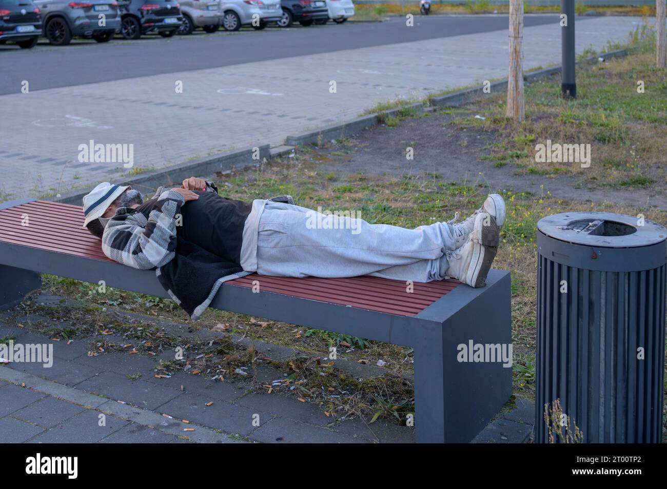 Un uomo che dorme su una panchina Foto Stock