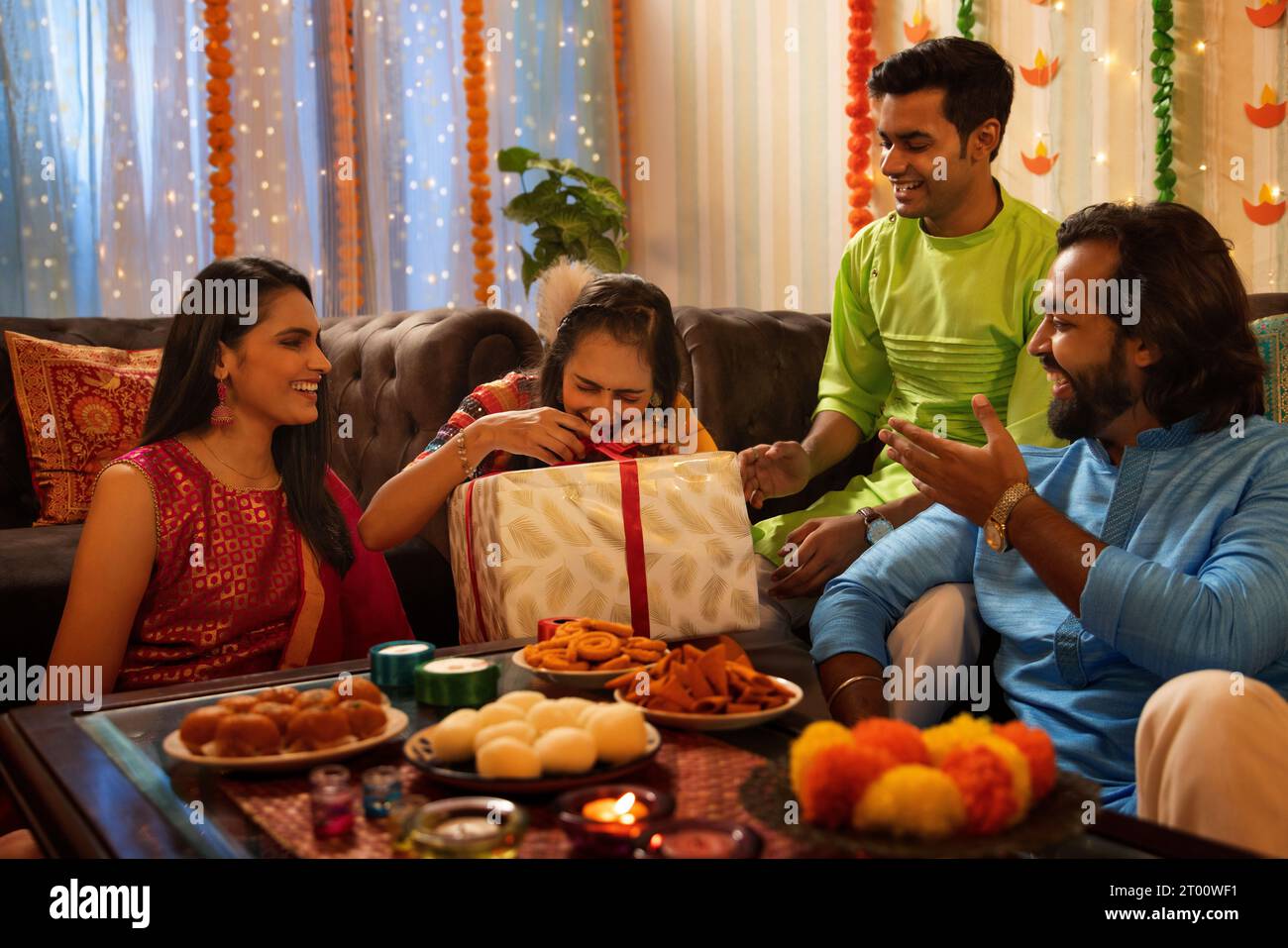 Gli amici aprono il regalo durante la festa di Diwali Foto Stock