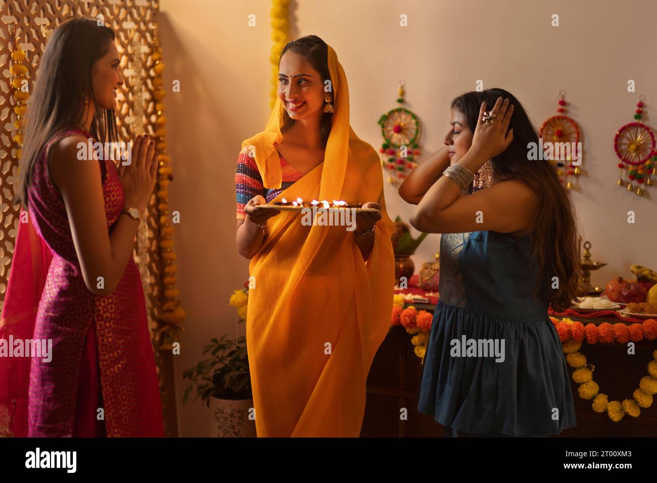 Donne indiane che pregano Dio a casa in occasione del Diwali Foto Stock