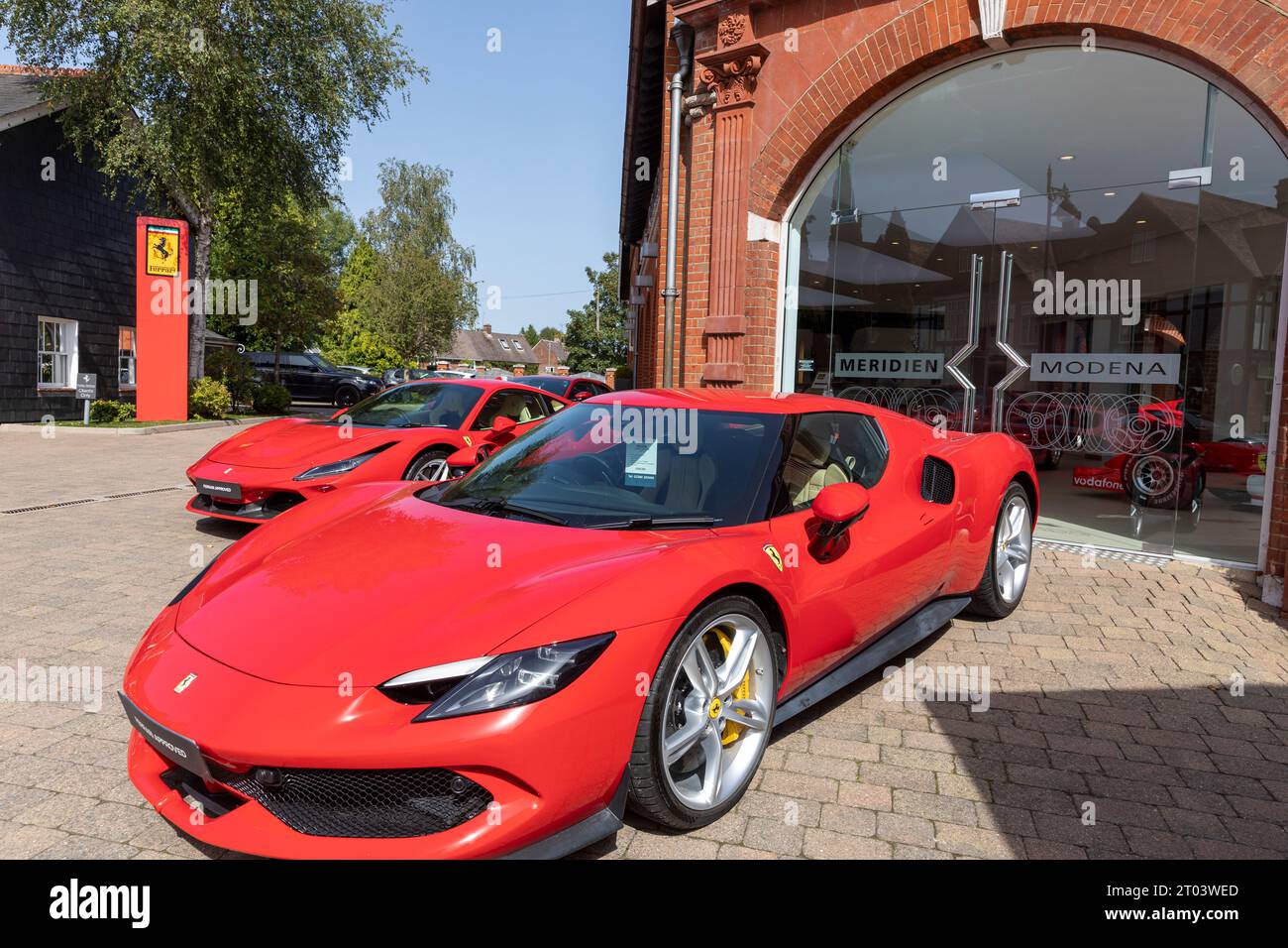 Concessionaria di auto sportive Ferrari, Meridien Modena a Lyndhurst, Hampshire, con Ferrari rosse sul piazzale, Inghilterra, Regno Unito Foto Stock