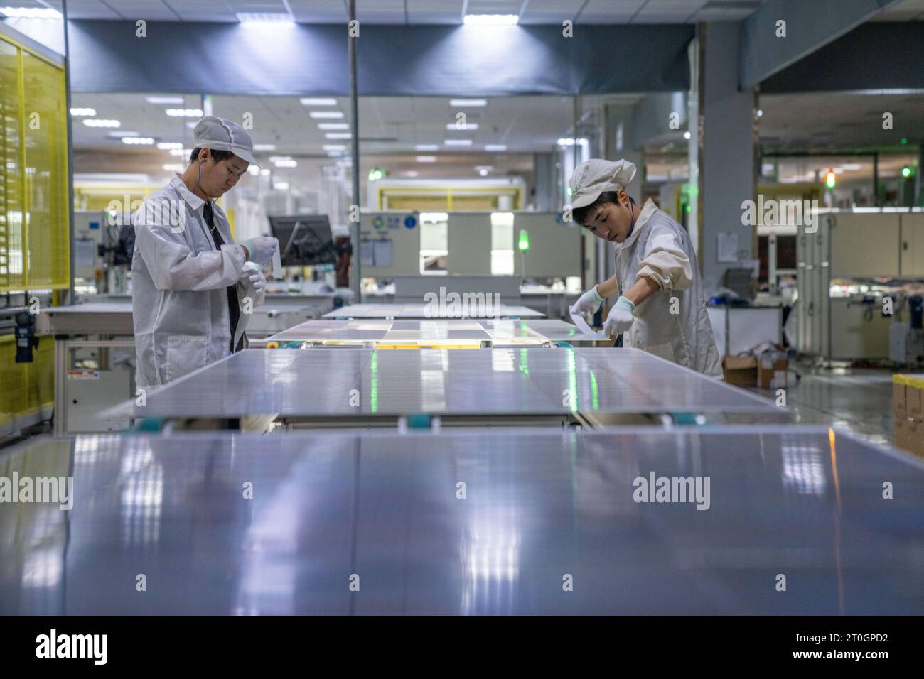 HEFEI, CINA - 7 OTTOBRE 2023 - due lavoratori producono prodotti fotovoltaici solari in un workshop di produzione di moduli fotovoltaici di New Energy Technology Foto Stock