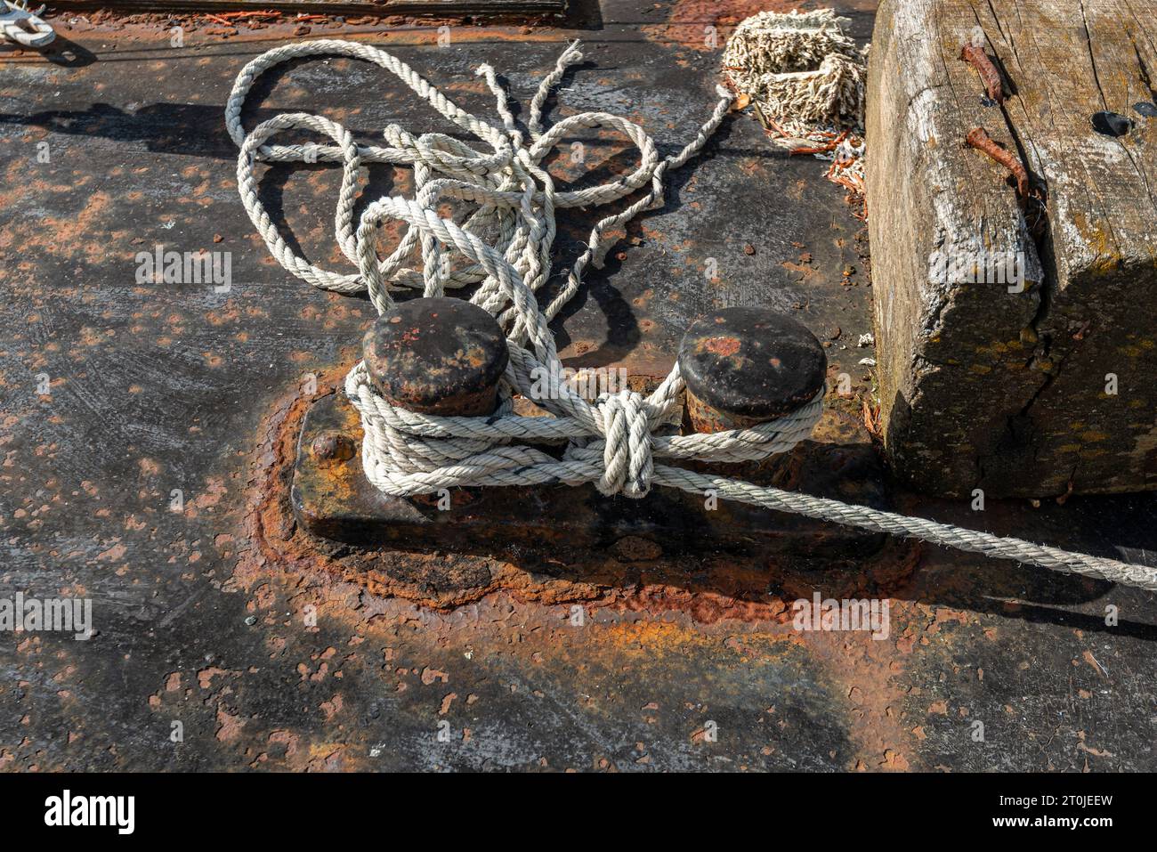 scarpa rugginita con linee di ormeggio per ormeggiare una barca Foto Stock