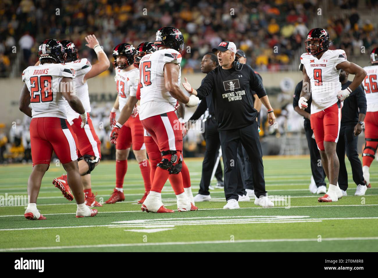 Benbrook, Texas, USA. 7 ottobre 2023. Il capo-allenatore della Texas Tech JOEY MCGUIRE (in nero) si congratula con il difensore della Texas Tech MACHO STEVENSON (16) per una giocata ben eseguita durante la vittoria di sabato sera del 39-14 sul Baylor al McLane Stadium di Waco. (Immagine di credito: © Brian McLean/ZUMA Press Wire) SOLO USO EDITORIALE! Non per USO commerciale! Foto Stock