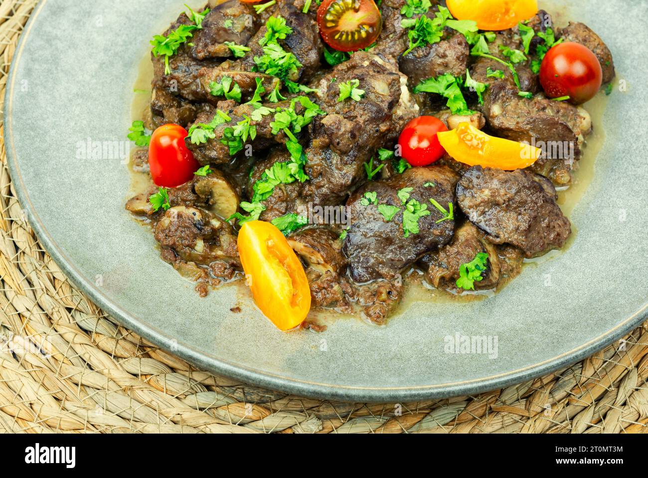 Fegato di pollo stufato con funghi e pomodori. Ricetta georgiana Foto Stock