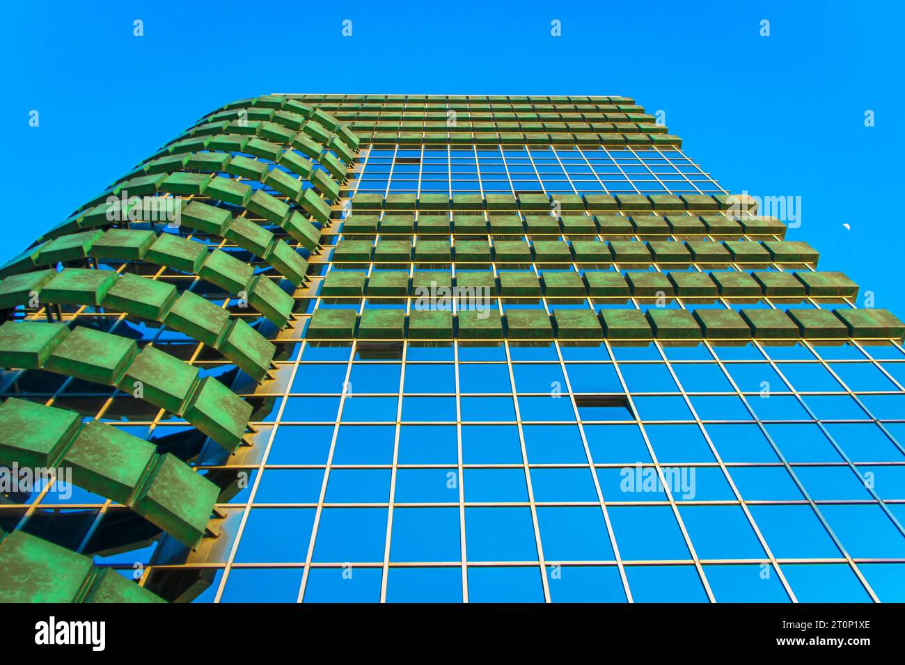 Torre alta e moderna nel quartiere degli affari della città con cielo blu chiaro Foto Stock