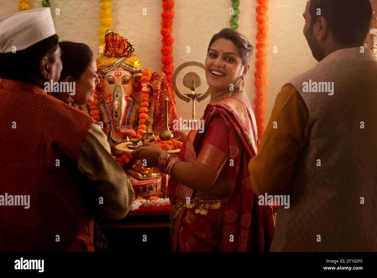 Famiglia Maharashtrian che prega il Signore Ganesha in occasione di Ganesh Chaturthi Foto Stock
