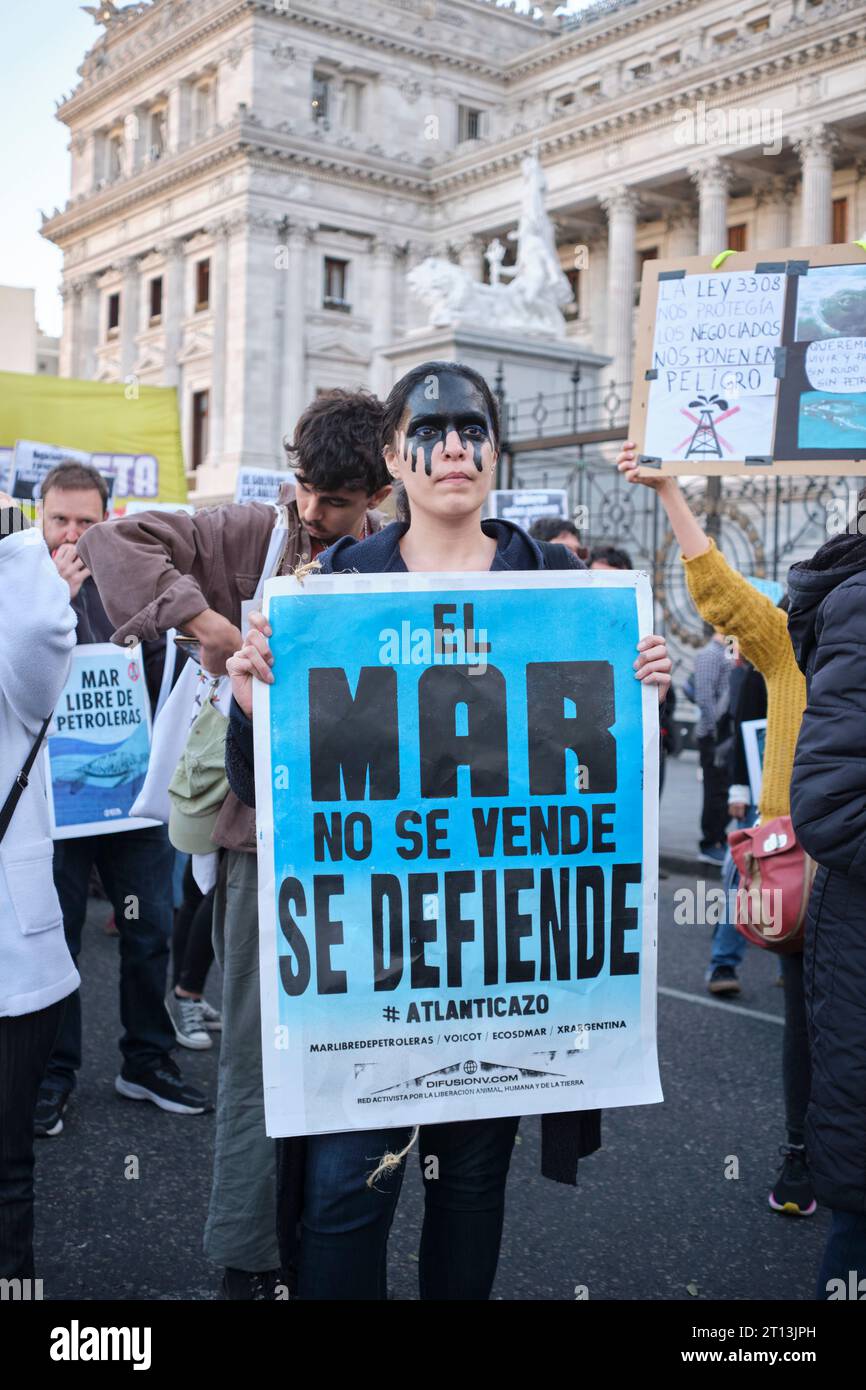 Buenos Aires, Argentina, 5 ottobre 2023: Persone che protestano contro l'esplorazione sismica per lo sfruttamento offshore del petrolio, donna che tiene un poster con il tex Foto Stock